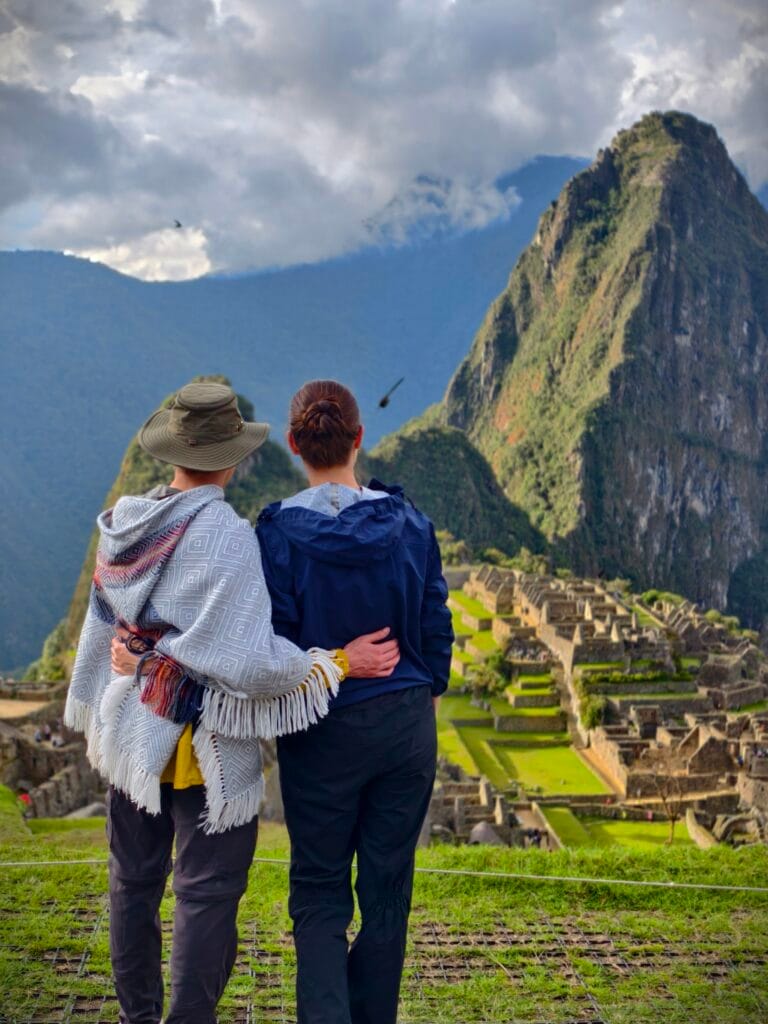 Couple posing at the classic Circuit 2 upper viewpoint overlooking the Machu Picchu ruins