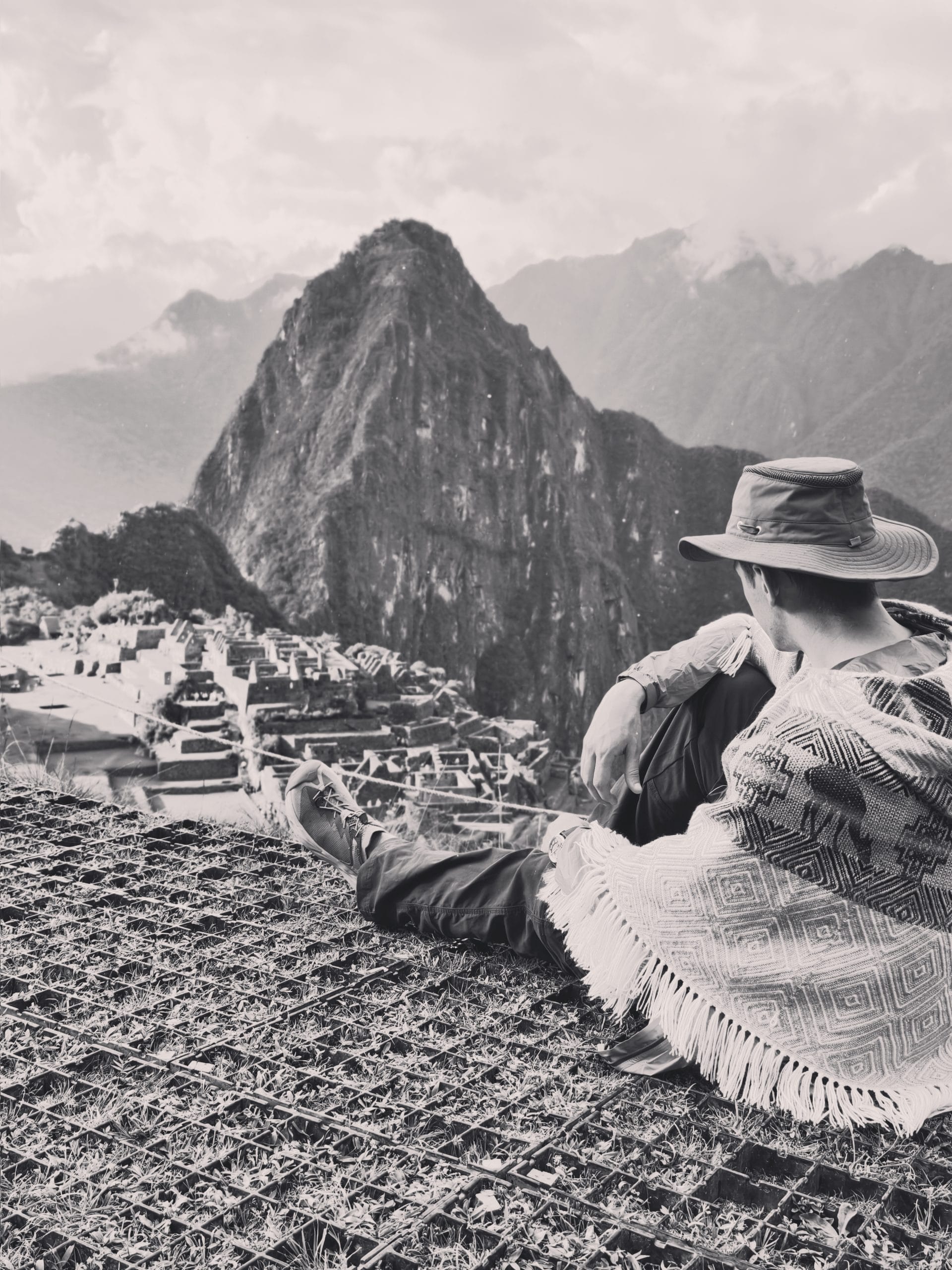 Traveler sitting at the Machu Picchu Circuit 2 viewpoint overlooking the ancient Inca ruins