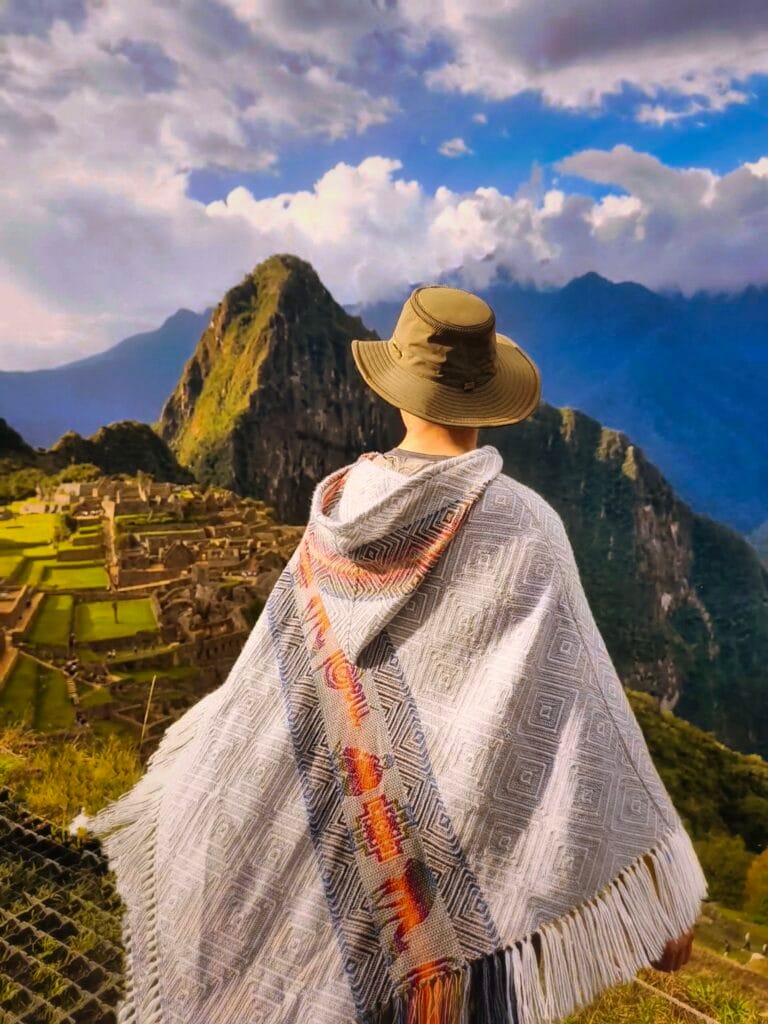 Man in traditional poncho at Machu Pichu viewpoint