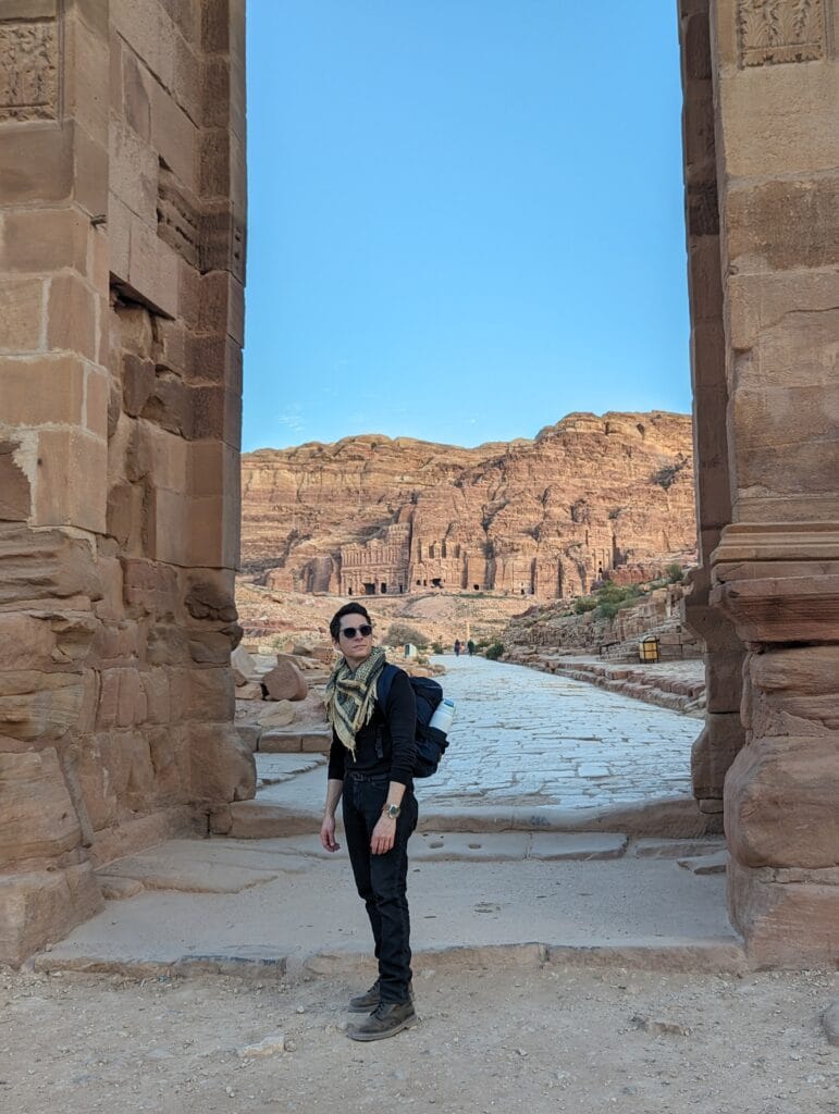 Scoot with backpack and shemag at gates visiting Petra, Jordan