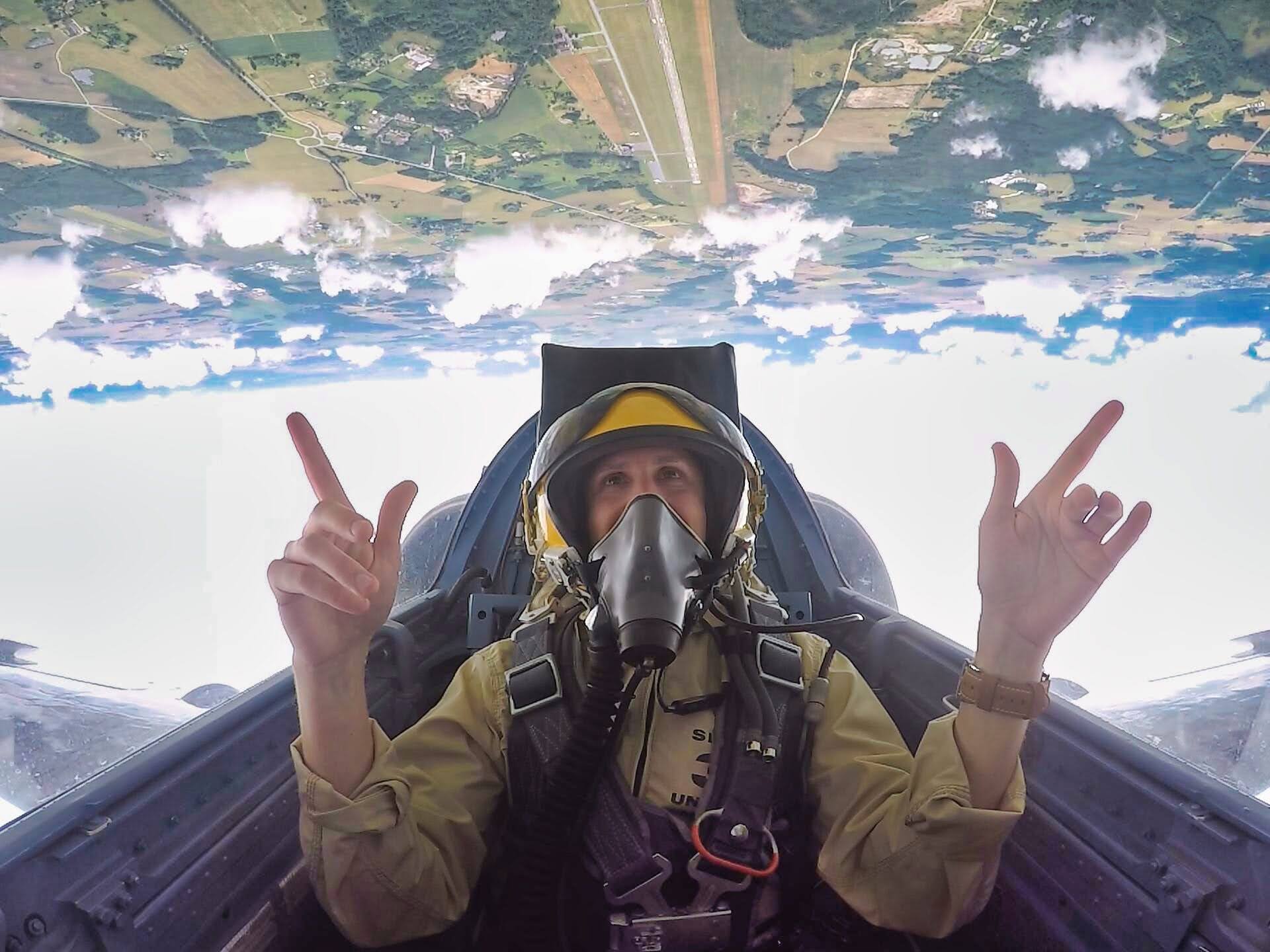 Scoot smiling while flying upside down during a loop as part of his fighter jet experience.
