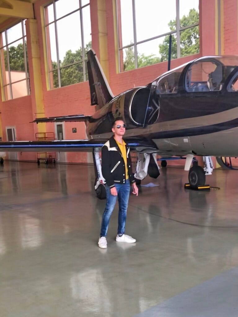 Scoot standing next to a Baltic Bees L-39 Albatros jet in the hangar before his flight.