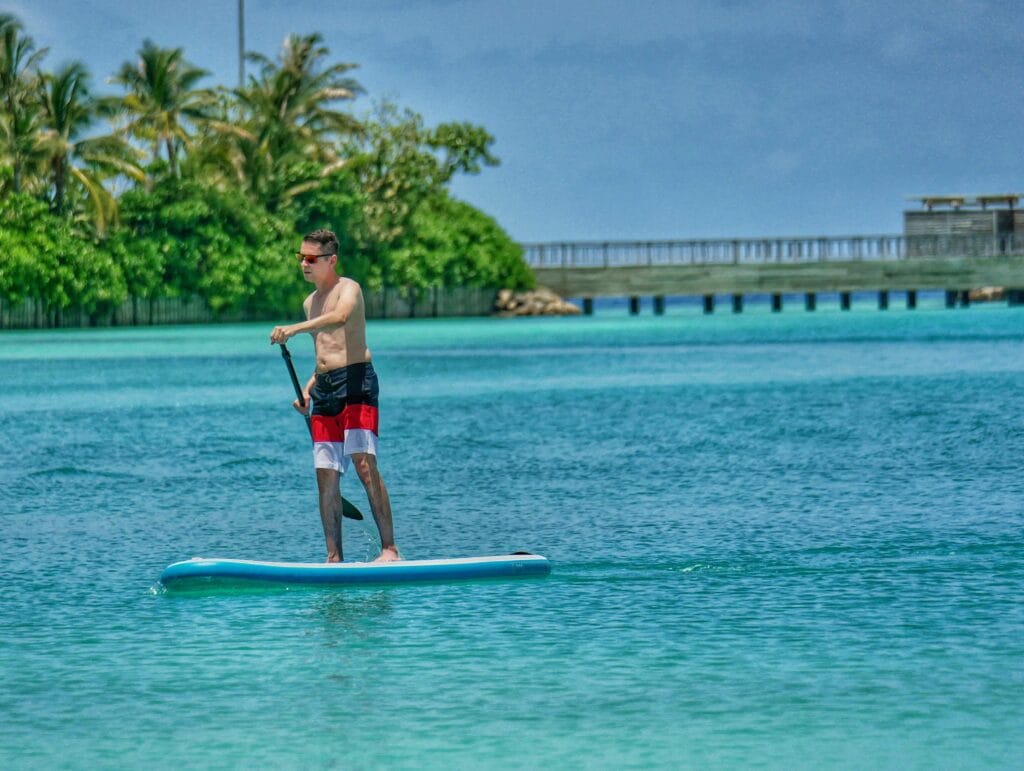 Scoot standup paddleboarding at a Maldives resort.