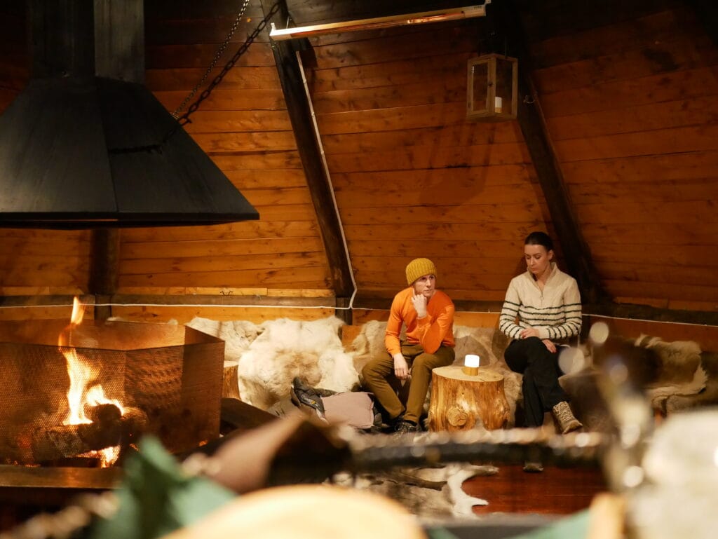 Traditional sami hut with fire and reindeer skins